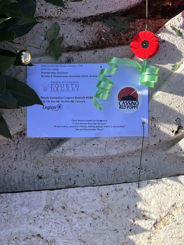 A red poppy placed in rememberence. Inspired by the wartime song “The Red Poppies on Monte Cassino,” the flower symbolizes bravery, sacrifice, and the blood‑shed of liberation.