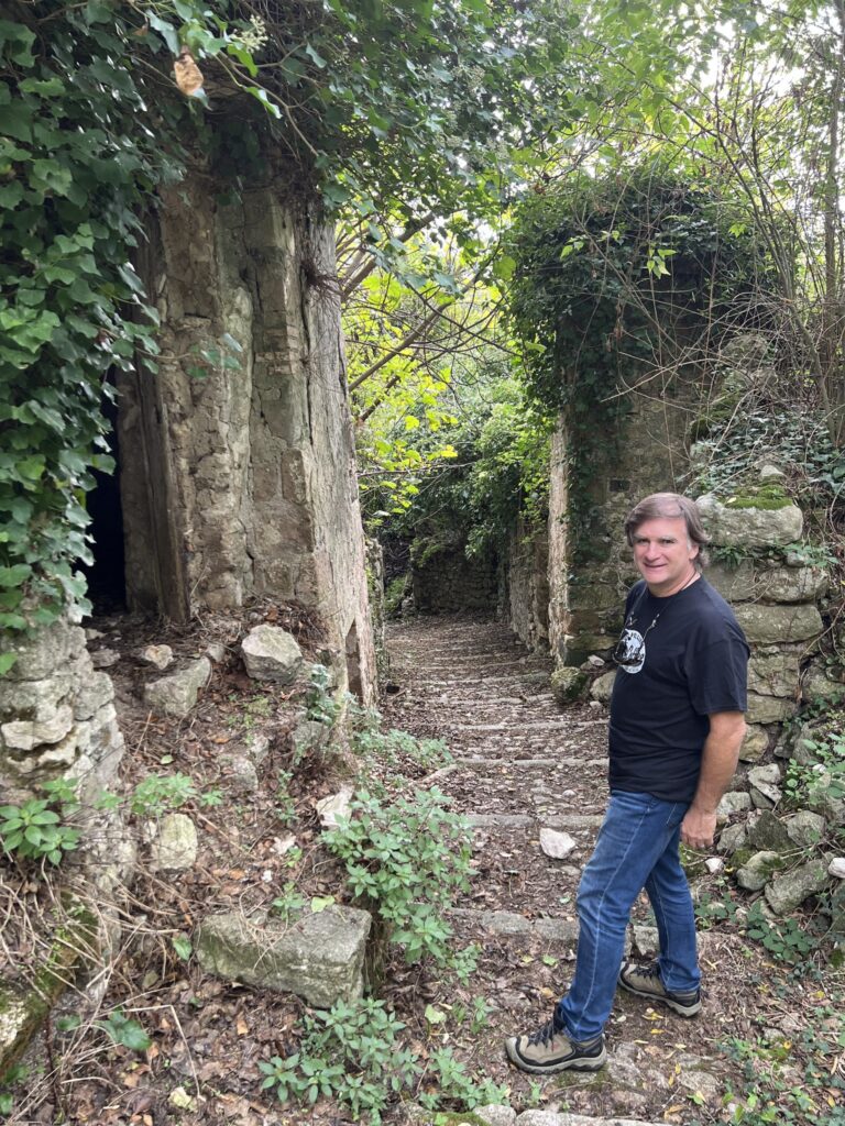 Many of the arched doorways of the Medieval homes are still standing, the houses they once opened into now filled with rubble.